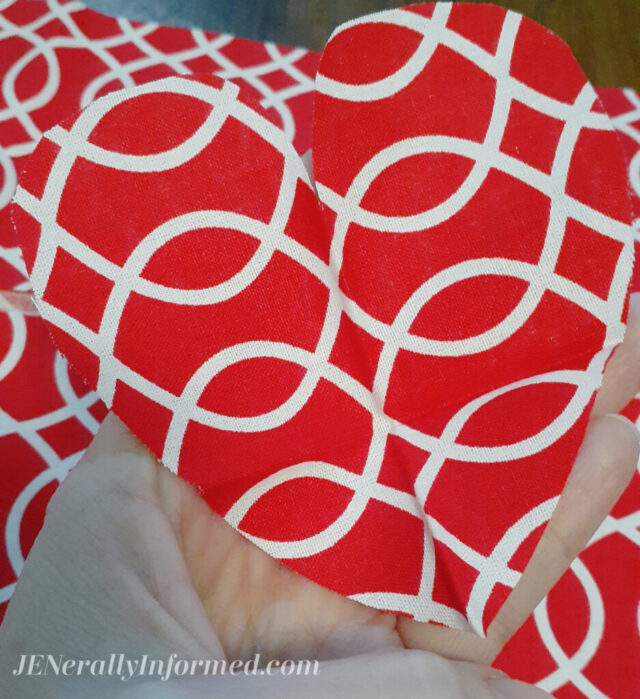 Here's how to make your own super easy Valentine's Day pillow in less than 20 minutes with just a few fabric scraps! #decor #valentinesdaydecor