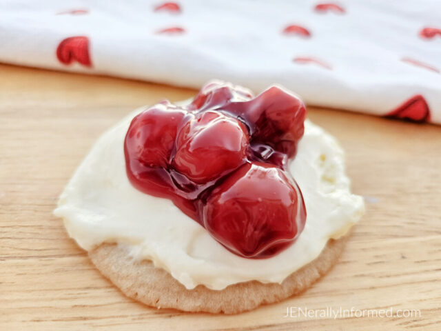 Quick, easy, and delicious—these sugar cookies topped with no-bake cheesecake and cherry filling will have you hooked! Ready in 45 minutes! #ValentinesDay #NoBakeDesserts #SugarCookies #EasyBaking