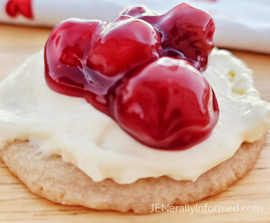 Quick, easy, and delicious—these sugar cookies topped with no-bake cheesecake and cherry filling will have you hooked! Ready in 45 minutes! #ValentinesDay #NoBakeDesserts #SugarCookies #EasyBaking