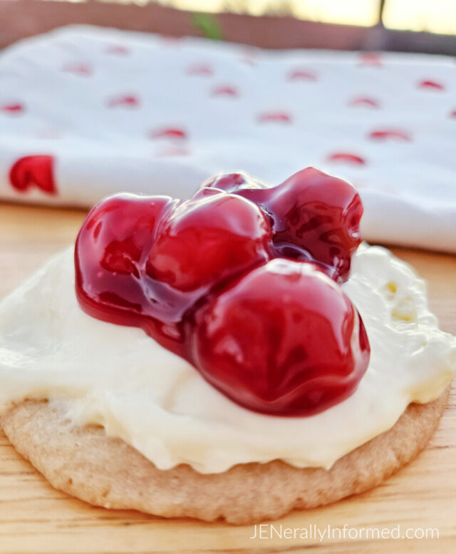 Quick, easy, and delicious—these sugar cookies topped with no-bake cheesecake and cherry filling will have you hooked! Ready in 45 minutes! #ValentinesDay #NoBakeDesserts #SugarCookies #EasyBaking